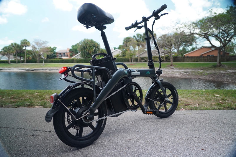 Rear oblique view of the Fiido L3 e-bike on the lake trail