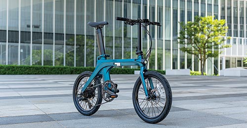 Front oblique view of the Fiido X e-bike under the city building