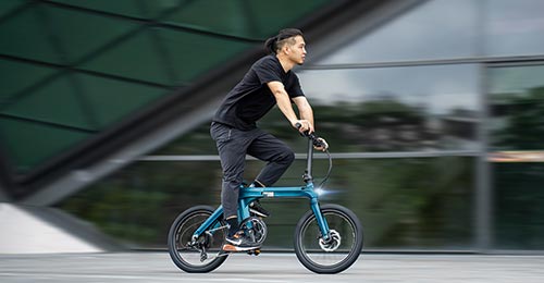 A man riding a Fiido X e-bike in the city